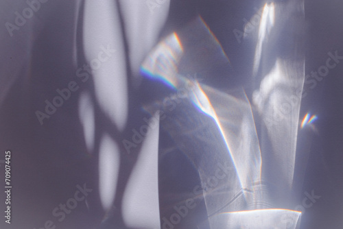 Sunlight background, abstract photo with light and shadow, glare and shine on paper texture, rainbow flare from sun, gray blue minimal aesthetic fon. Natural light and caustic effects. photo