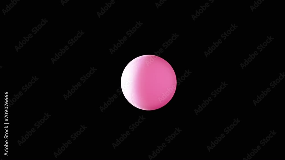 Rotating Pink Ball or Sphere Flies in Blank Space on a Black Background. Abstract. Plastic ball moves slowly across the screen, and balances in air flow. Levitation. Selective focus. Side lighting. Rotating Pink Ball or Sphere Flies in Blank Space on a Black Background. Abstract. Plastic ball moves slowly across the screen, and balances in air flow. Levitation. Selective focus. Side lighting.