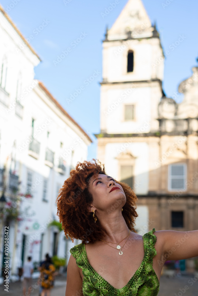 Beautiful red-haired woman looking up. Happy person traveling.