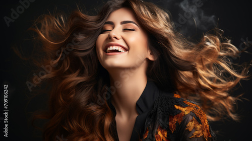 Woman with red hair smiles as the wind blows through her locks, radiating happiness.