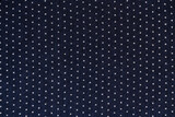 abstract background of dark blue and white polka dot knit fabric texture close up