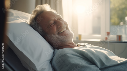 Smiling old man in hospital bed, health insurance. Good care from hospital.