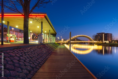 A bridge in the city at night. City lights. The Galaxy Bridge, Purmerend, Netherlands. The bridge on the blue sky background during the blue hour. Architecture and design.