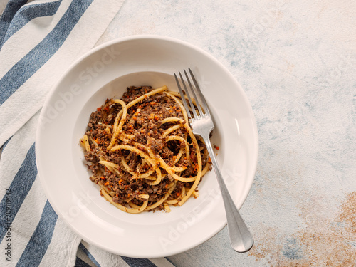 Spaghetti bolognese with minced meat or Makarony Po Flotski or Russian Navy Style Pasta. Top view. Navy spaghetti in plate, copy space. photo