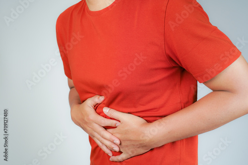 Wallpaper Mural male having stomach ache, bending over and holding hands on stomach, uncomfortable due to stomach cramps, gastric pain Torontodigital.ca