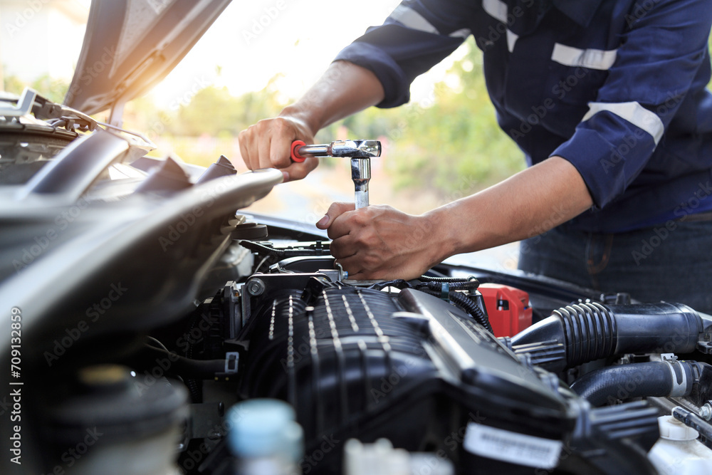 Automobile mechanic repairman hands repairing a car engine automotive workshop with a wrench, car service and maintenance,Repair service. Automobile mechanic repairman hands repairing a car engine automotive workshop with a wrench, car service and maintenance,Repair service.