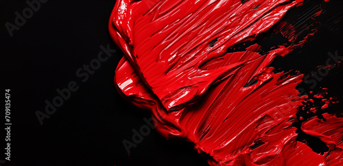 Red oil paint on a black background. Handmade oil paint brush strokes isolated over the black background 