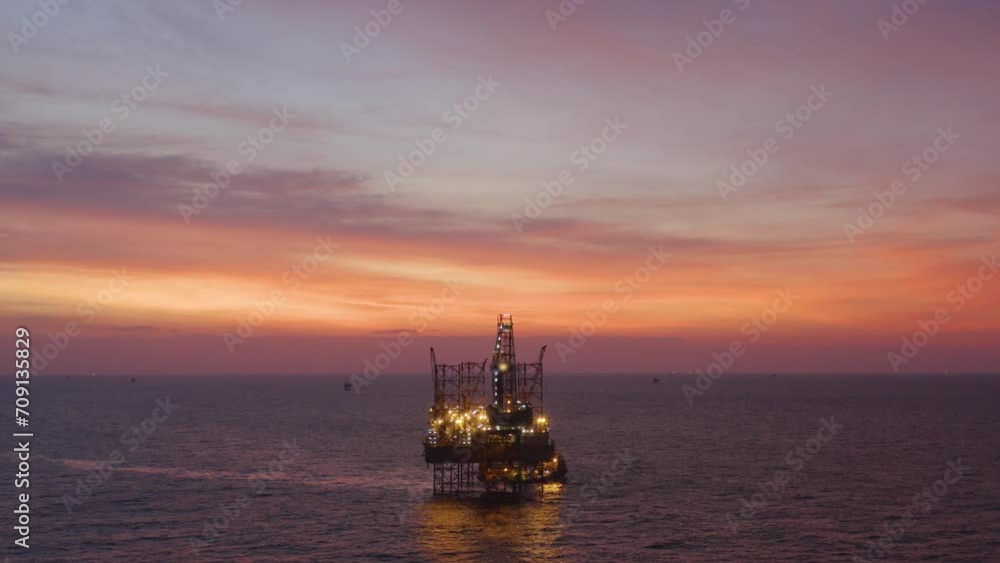 Aerial view of silhouette offshore jack up drilling rig during sunset - oil and gas industry Aerial view of silhouette offshore jack up drilling rig during sunset - oil and gas industry
