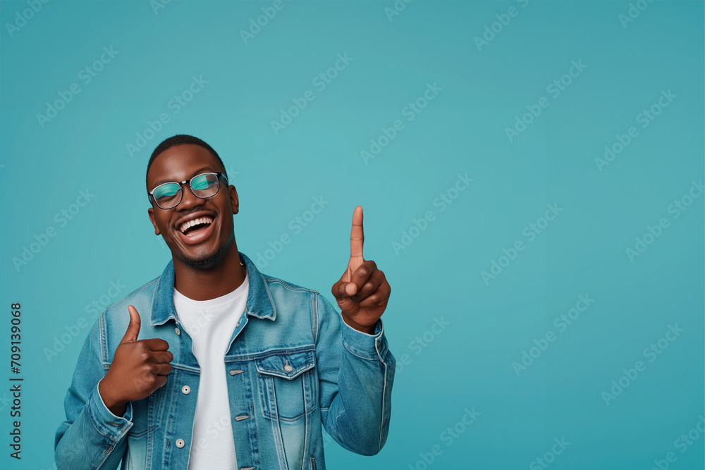 Naklejka premium Banner Cheerful african man wearing glasses jean jacket having white snow smile pointing fingers aside at copy space for your text advertisement, advertise teeth whitening or eyewear store good offer 