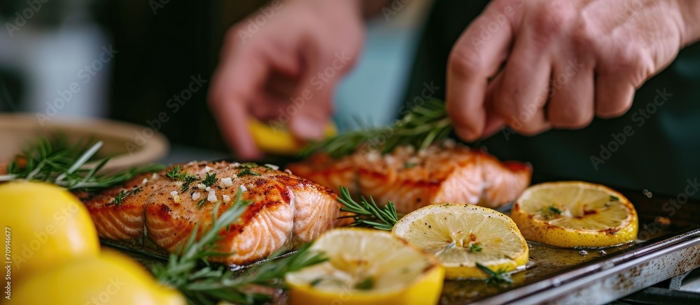 Man prepares nutritious diet by cooking omega-rich salmon fillet with lemons.