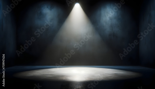 An empty stage illuminated by a single dramatic spotlight, suggesting anticipation of a performance or event