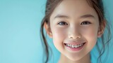 Cute Asian girl in braces happy smile. Medical orthodontic treatment braces for a beautiful kid smile