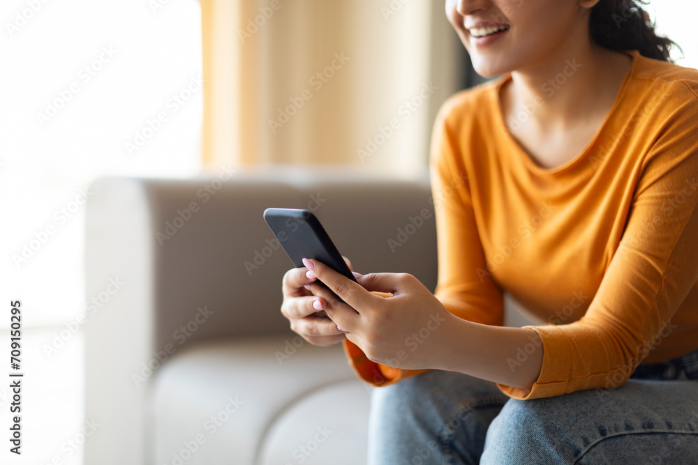 Happy Young Woman Texting On Smartphone While Relaxing On Couch At Home Happy Young Woman Texting On Smartphone While Relaxing On Couch At Home