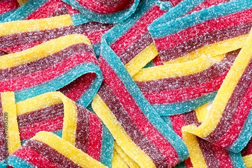 Close up of rainbow colored sugar coated candy strips