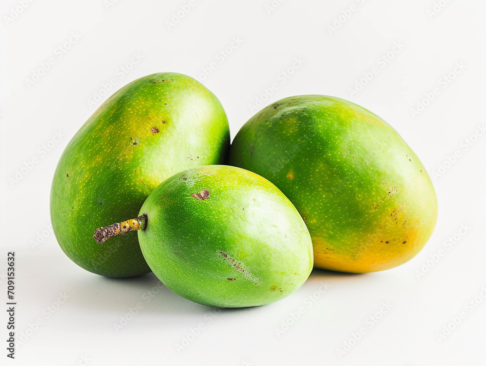 Fresh green tropical mangoes isolated on white background. Minimalist style.
Fresh green tropical mangoes isolated on white background. Minimalist style.