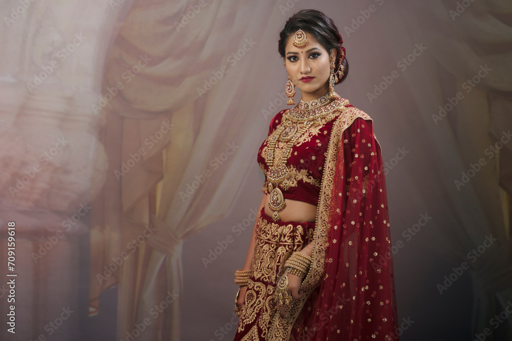 Young Indian female in ethnic Indian wear celebrating festival of Diwali. Indian female with bridal make-up and bridal wear