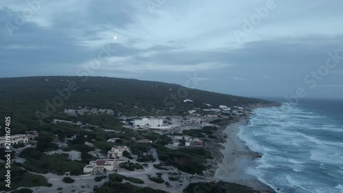 Full Moon Rising Over Formentera s Iconic Coastline at Dusk photo