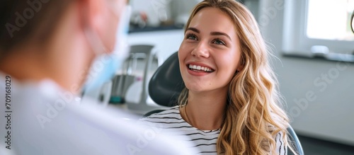 Female patient and orthodontist review smile and dental work. photo