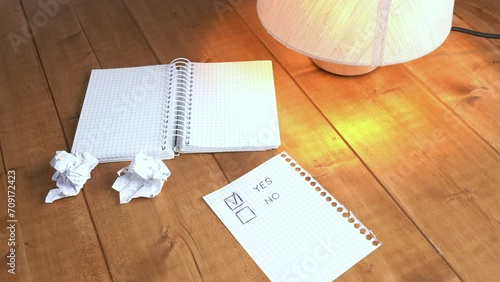 A man ticks the box against the word yes.
