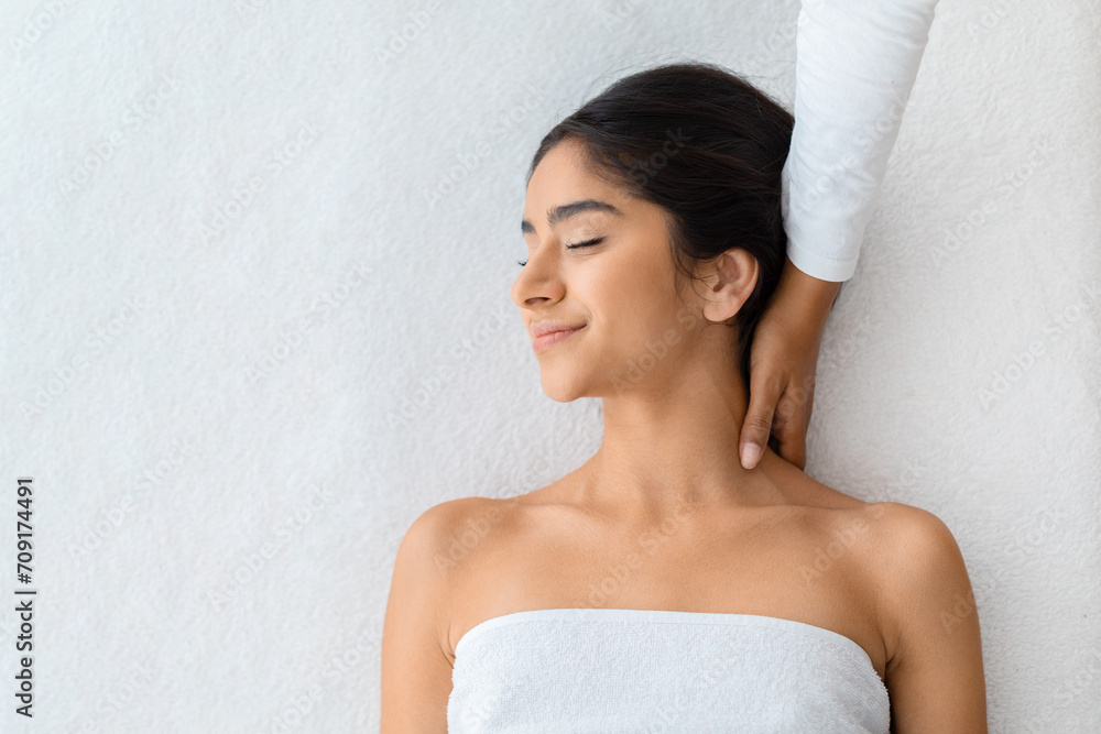 Top view of eastern woman receiving relaxing neck massage Top view of eastern woman receiving relaxing neck massage