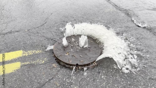 Manhole Cover Flooded at Road Yellow Center Lines
