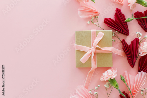 Valentines day flat lay. Stylish pink and red hearts, flowers and gift box on pink background, copy space. Happy Valentines day! Modern hearts paper cutouts and box. Love and mother's day © sonyachny