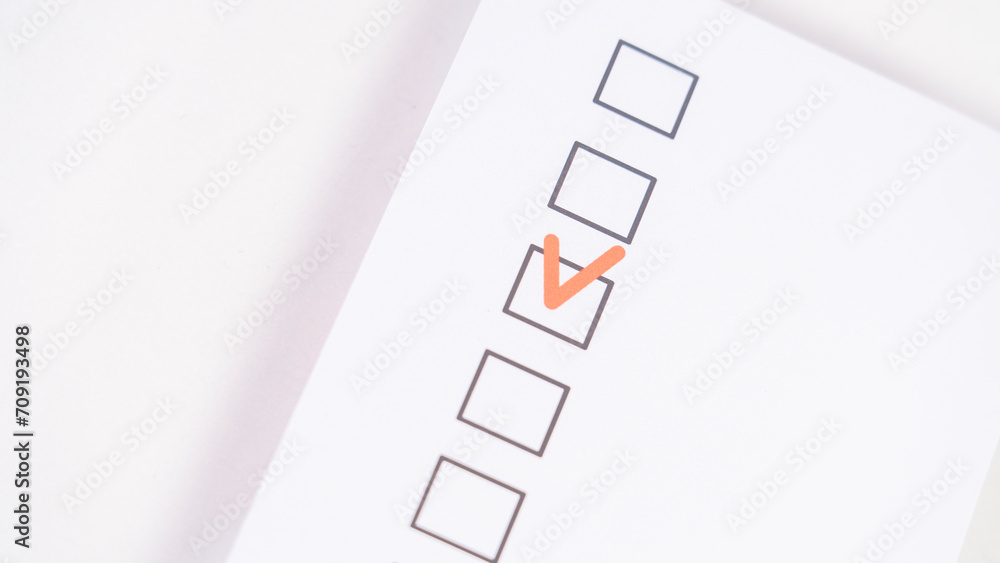 A form with a checkbox for selection and a red checkmark, a concept of choice, Checkbox with red Check mark, red check mark on paper, Agree, check boxes on white sheet. Red check mark