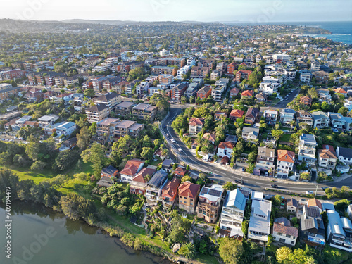 Aerial view of a picturesque residential neighborhood nestled alongside a serene body of water