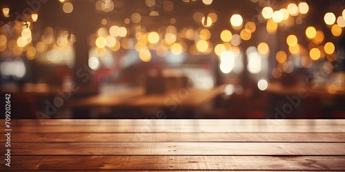Blurred restaurant lights against wooden table background