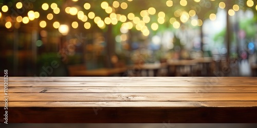 Blurred cafe/restaurant background with empty wooden table.