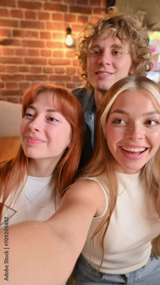 Young company taking selfies and drinking cocktails. Young company taking selfies and drinking cocktails.