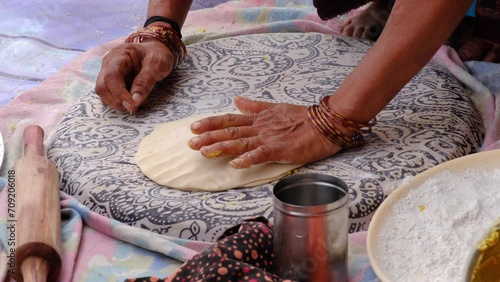 Indian Women Preparing mande ( PURAN POLI ) - typical Maharashtrian Sweet food in Bhimthadi Jatra, Pune, To uplift the culture and traditional Food with an active platform. photo