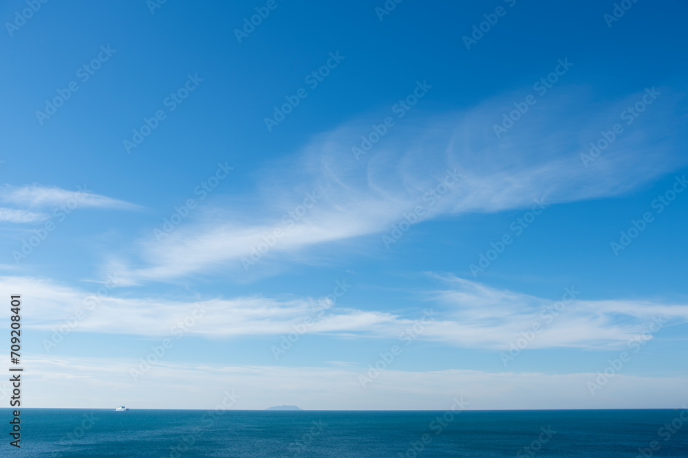Seascape with gradient white clouds