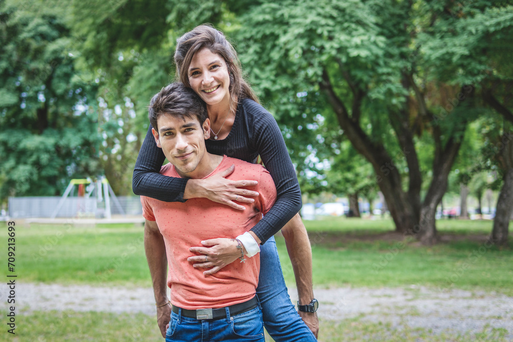 Fototapeta premium Boyfriend carrying his girlfriend on piggyback.