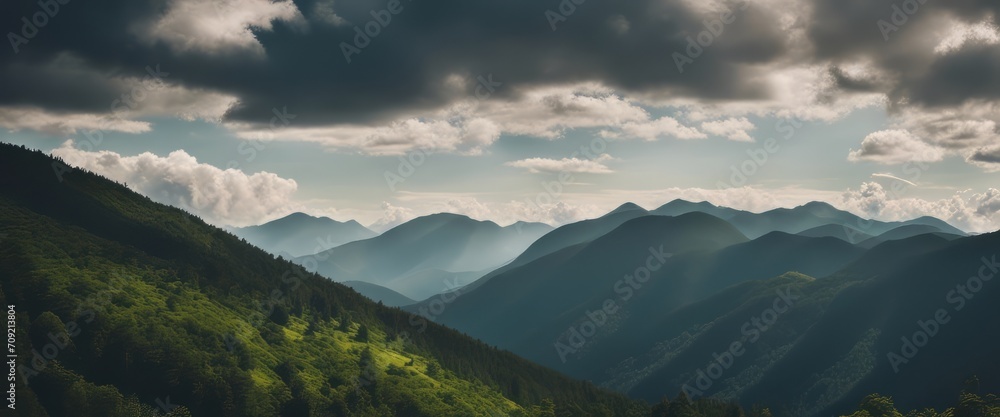 Amazing wild nature view of layer of mountain forest landscape with cloudy sky. 