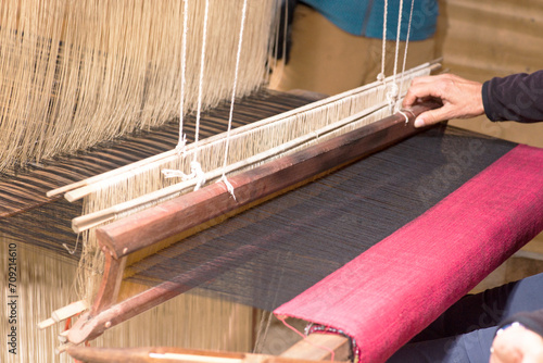 Fotografija A woman works a handloom in Laos, Lao Prabang region