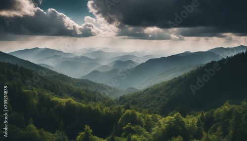 Amazing wild nature view of layer of mountain forest landscape with cloudy sky. 