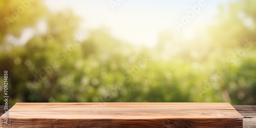 Vertical wooden table with blank space for your product or advertising text against blurred natural background.