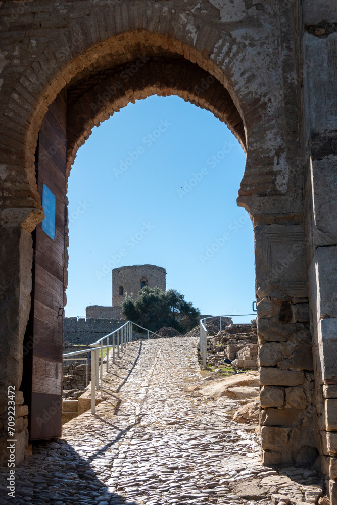 View of the entrance gate to the castle of Jimena de la Frontera, a beautiful village in the province of Cadiz, Andalusia, Spain.