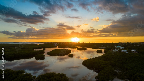 Sunset over Rock Harbor mangroves with reflection on water in Florida Keys