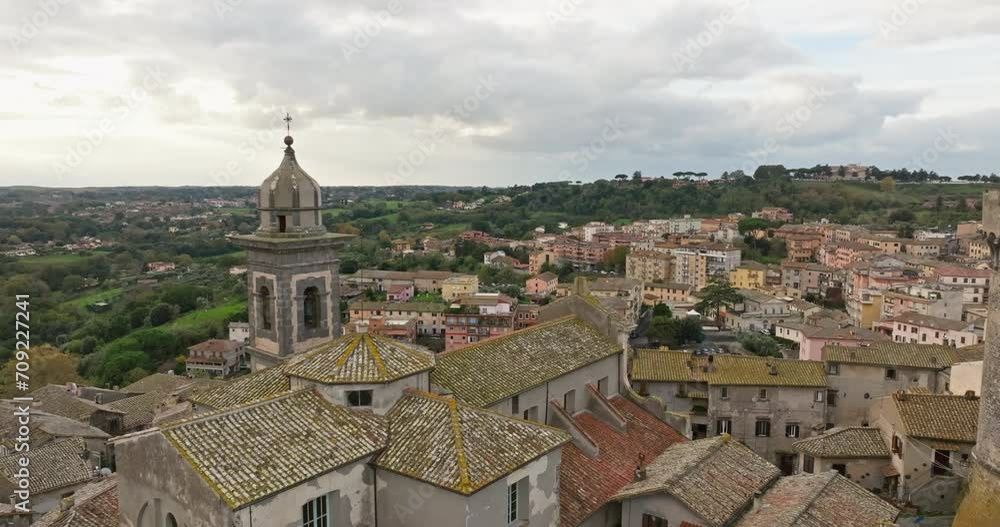 Aerial view Braciano Italy. A historic cathedral in an ancient town with old houses on the shore of a lake. High quality 4k footage Aerial view Braciano Italy. A historic cathedral in an ancient town with old houses on the shore of a lake. High quality 4k footage