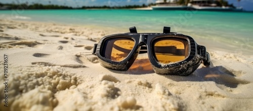 Diving goggles and snorkeling equipment on the beach sand