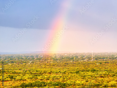 aerial view of a rainbow after the rain, african village