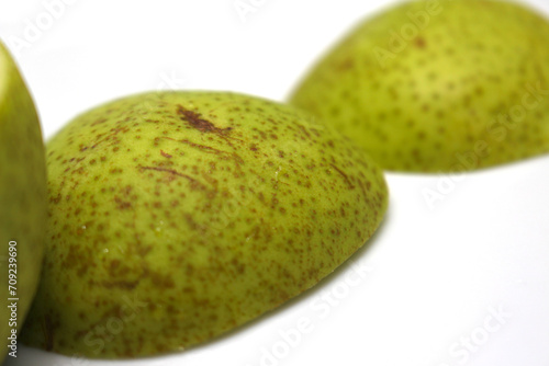 fresh green pear. cut green pear. green fruit details. pear with selective focus.