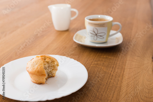 Fototapeta Naklejka Na Ścianę i Meble -  Bite-sized muffin with coffee and milk for breakfast