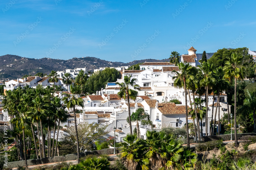 White houses in the city of Nerja, Andalusia, Spain. View of the city and mountains.