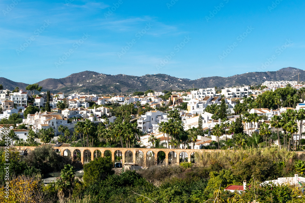 White houses in the city of Nerja, Andalusia, Spain. View of the city and mountains.