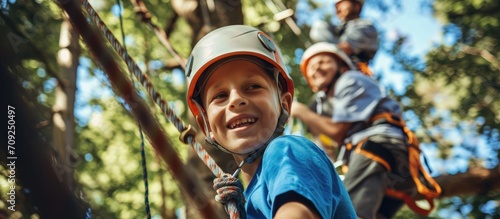 Father and son climbing together at adventure park. photo