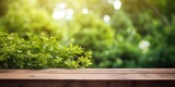 Wooden table with green garden backdrop and blurred foliage.