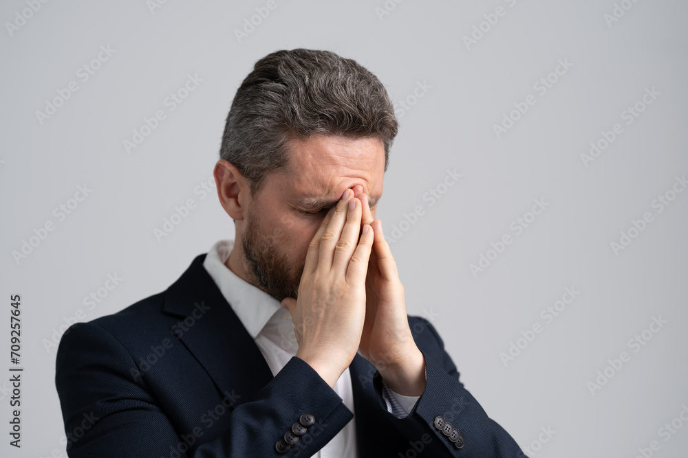 Business man got migraine touches head because of pain. Tired exhausted man suffering from headache. Business problems. Head pain migraine. Business man in suit with migraine. Job Strain Business man got migraine touches head because of pain. Tired exhausted man suffering from headache. Business problems. Head pain migraine. Business man in suit with migraine. Job Strain